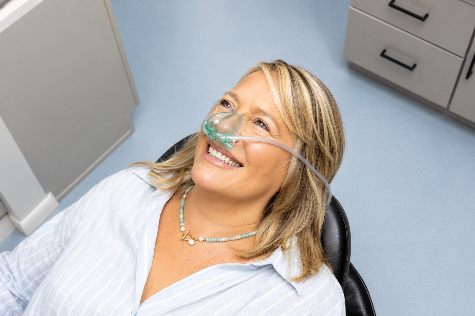 Emergency dentist showing X-ray results to patient in dental chair in Carrollwood Village, FL