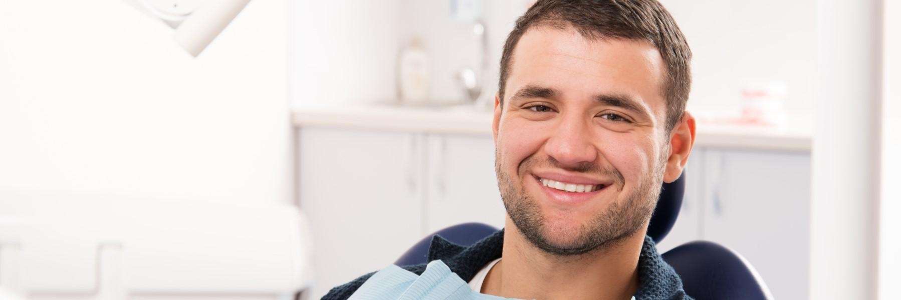 An image of a man smiling after removing clear braces in Tampa, FL