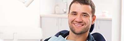 Happy man at the dentist | dental insurance Tampa, FL