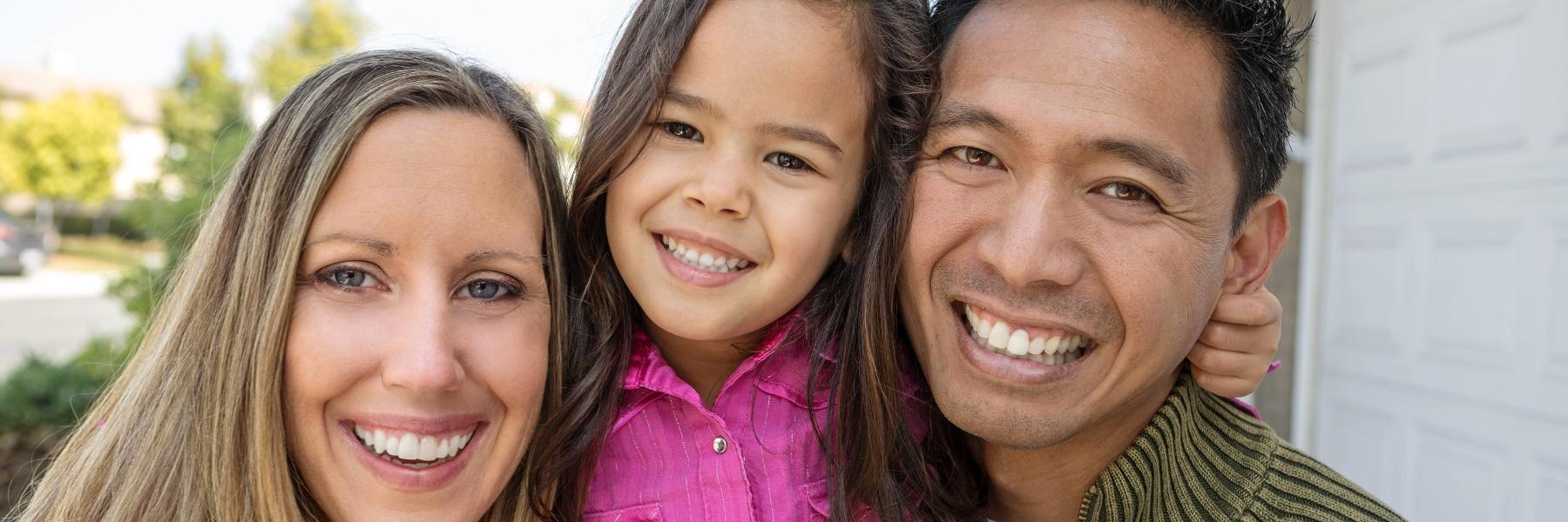 Family smiling after teeth whitening in Tampa, FL