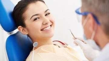 Woman smiling during dental cleaning in Tampa, FL