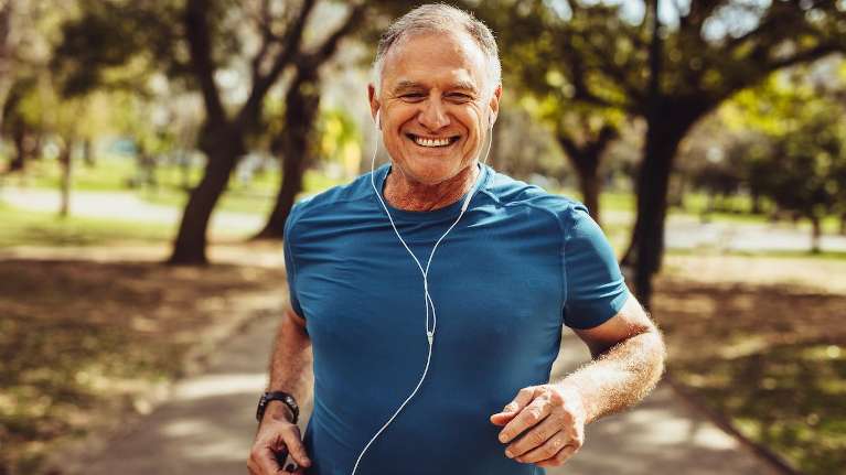 Man jogging happily after getting dentures from Carrollwood Village Dental