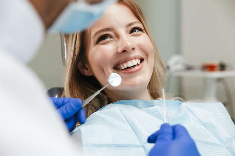 A woman smiling after getting Tooth-Colored Fillings in Tampa