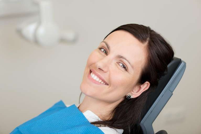 A happy woman getting her Dental Implants and Dentures in Tampa, FL