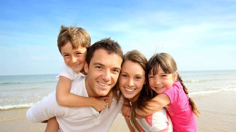 Family smiling after getting tooth colored fillings from Carrollwood Village Dental