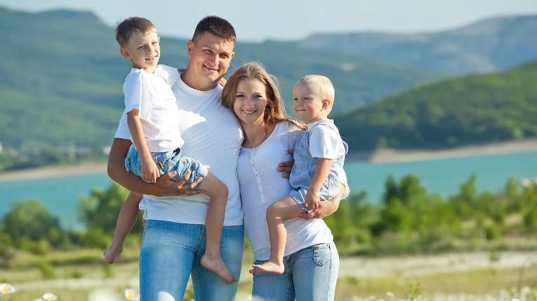Family posing for a photo after teeth cleaning in Tampa, FL