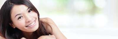 Woman smiling on a patio after cosmetic dentistry in Tampa, FL