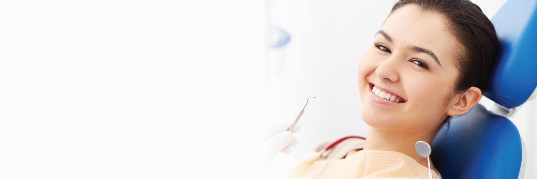 Woman smiling in dental chair for TMJ treatment in Tampa FL