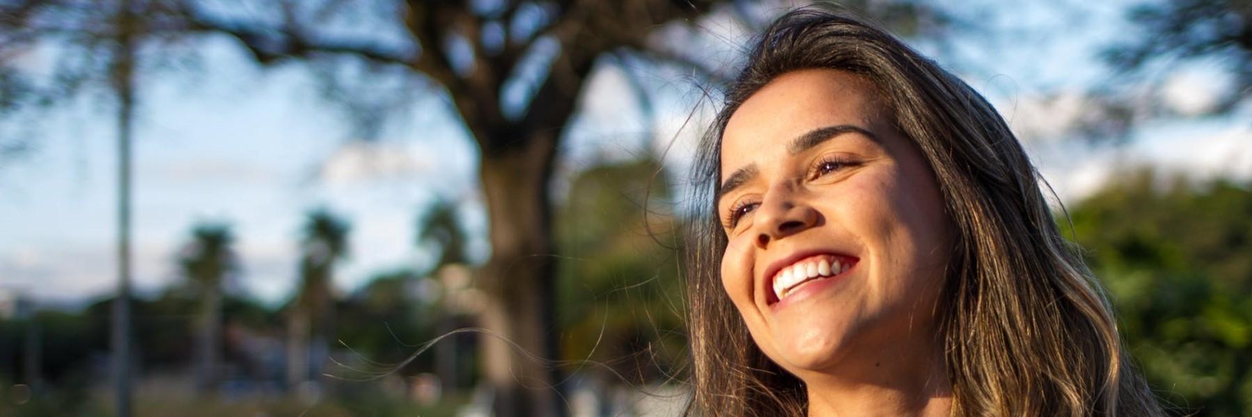 Woman smiling outside wearing tooth colored fillings in Tampa FL